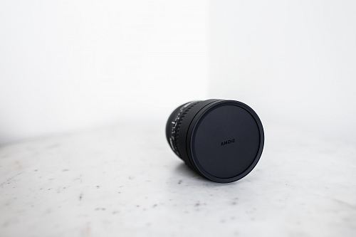 black camera lens on white surface
